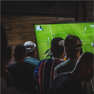 Caption: Friends watching a football game together.